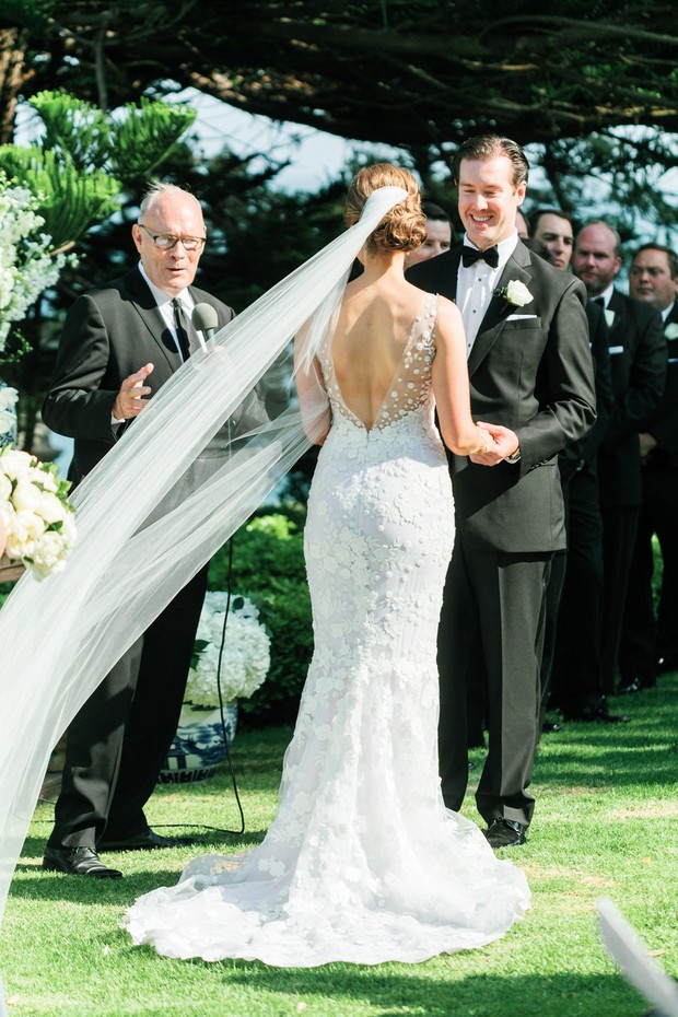 Bride and groom exchanging vows at outdoor wedding ceremony