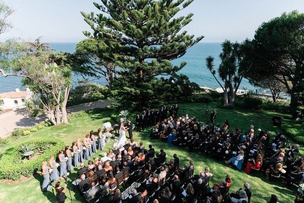 Outdoor wedding ceremony on lawn overlooking ocean