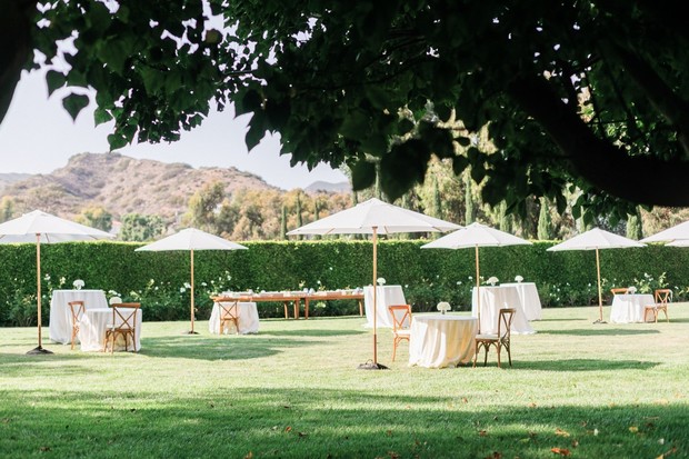 Outdoor wedding reception with tables and umbrellas