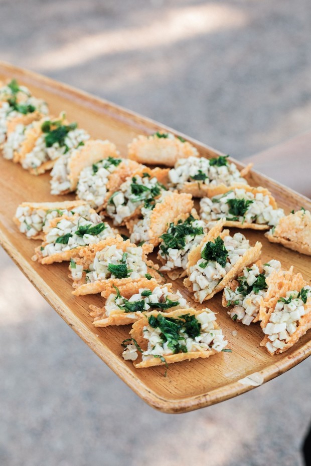 Crispy appetizer bites with crab and herb on wood tray