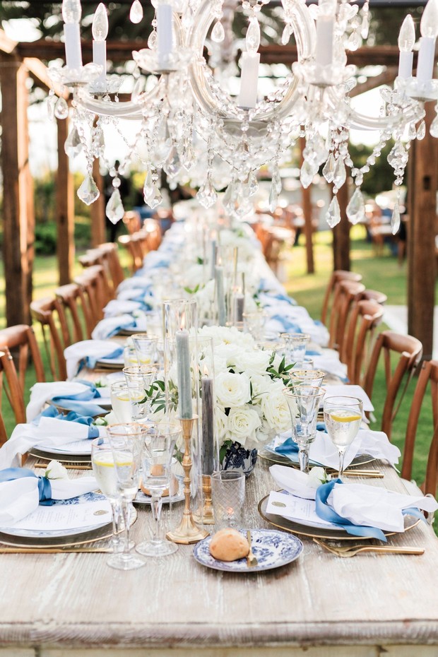 Elegant wedding reception table setting with crystal chandelier