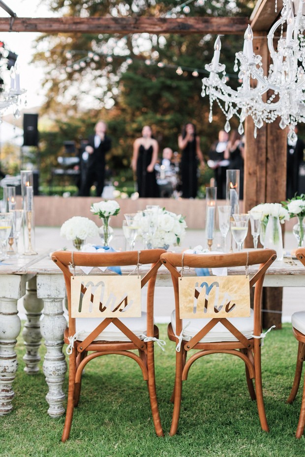 Mr and Mrs chairs at elegant outdoor wedding reception