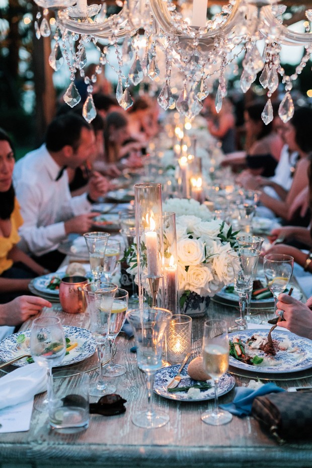 Elegant outdoor wedding reception dinner with chandelier