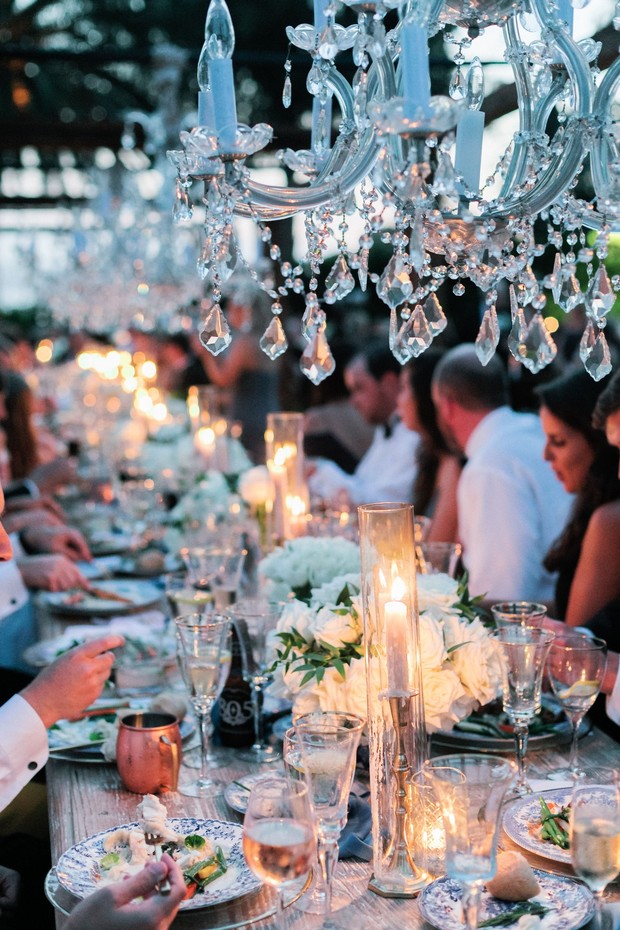 Elegant crystal chandeliers over a wedding reception table