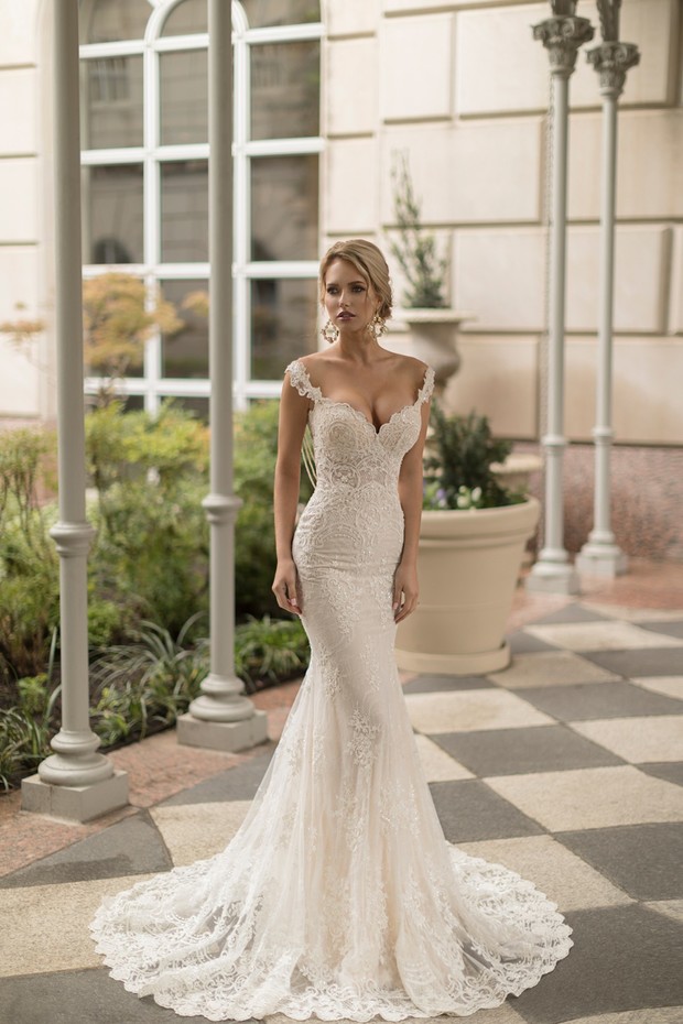 Woman in off the shoulder lace mermaid wedding dress