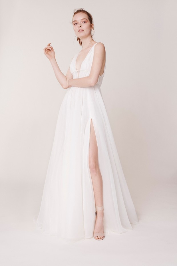 Elegant woman in a white high-slit gown