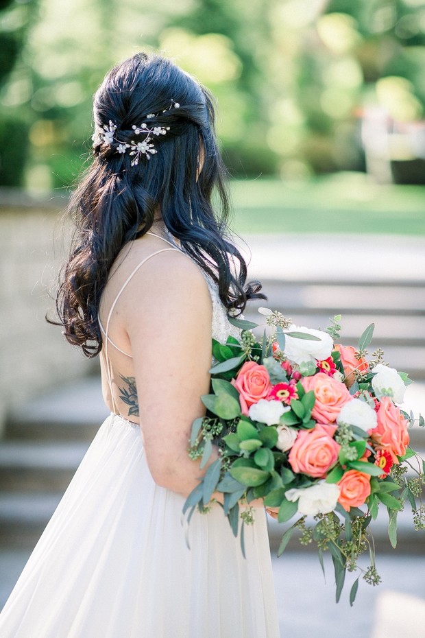 bridal half up hair with coral bouquet