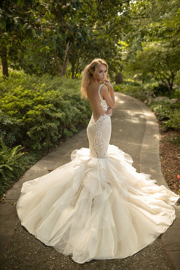 Bride in a stunning open back wedding dress in a garden