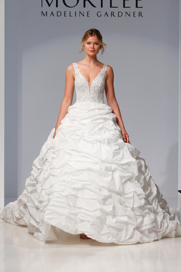 Madeline Gardner model wearing a white wedding gown