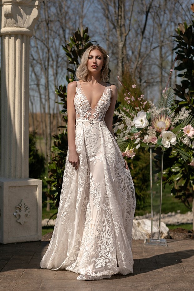 Bride in ornate lace wedding dress outdoor portrait