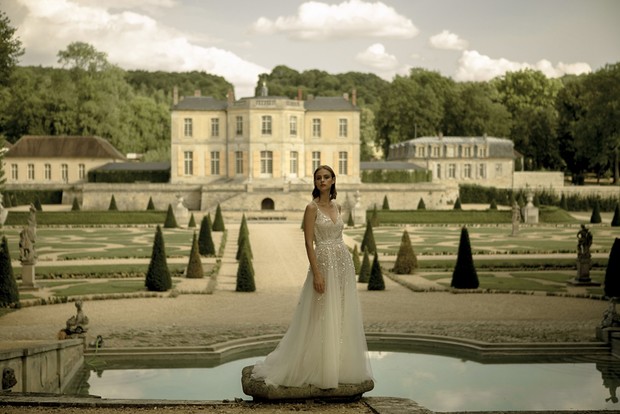 Elegant bride in wedding dress at a grand estate garden