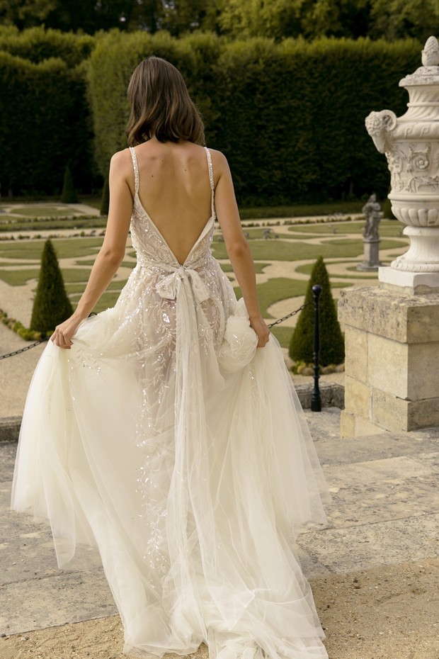 Elegant bride in backless embellished wedding gown