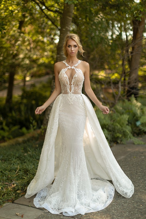 Blonde bride in a lace wedding dress with long train