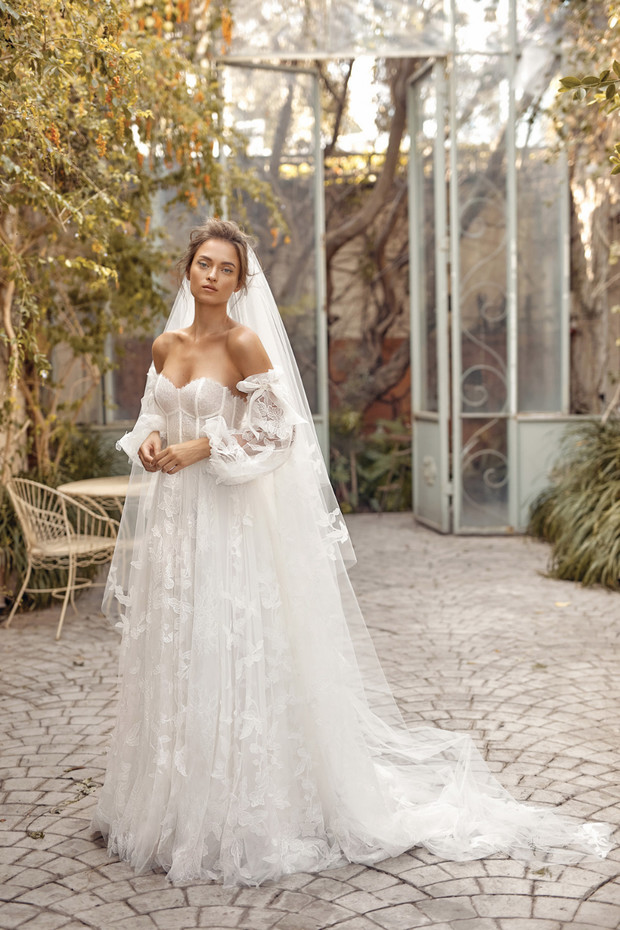 Elegant bride in lace wedding gown with long veil