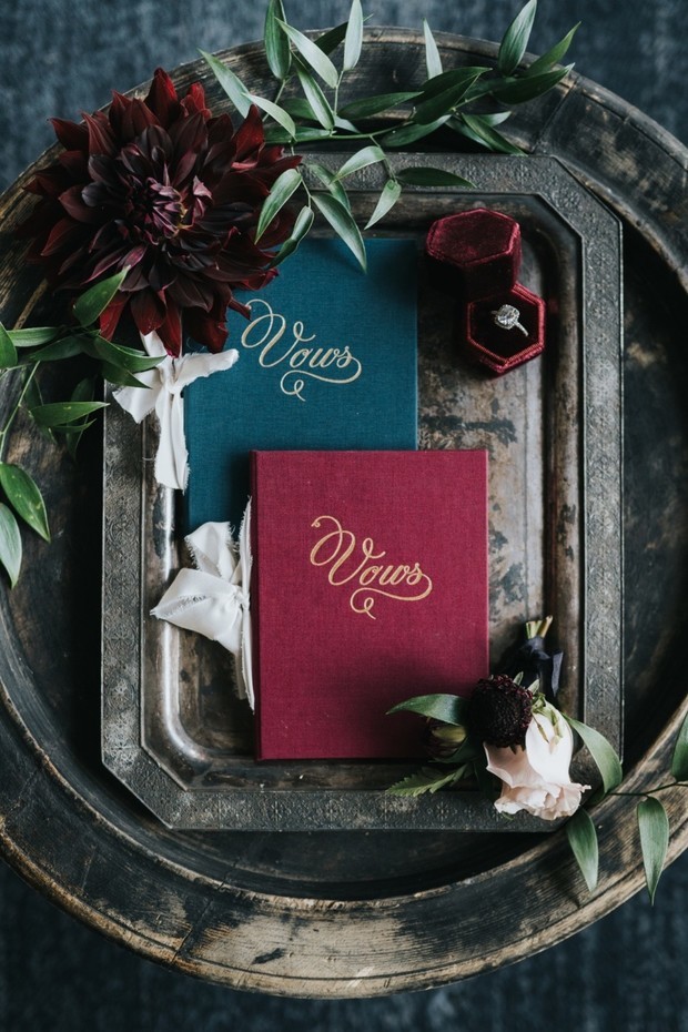Wedding vows books with flowers and engagement ring details