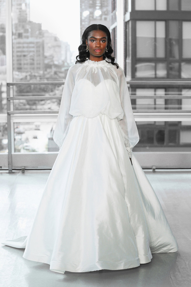 Elegant bride in white wedding dress with city backdrop