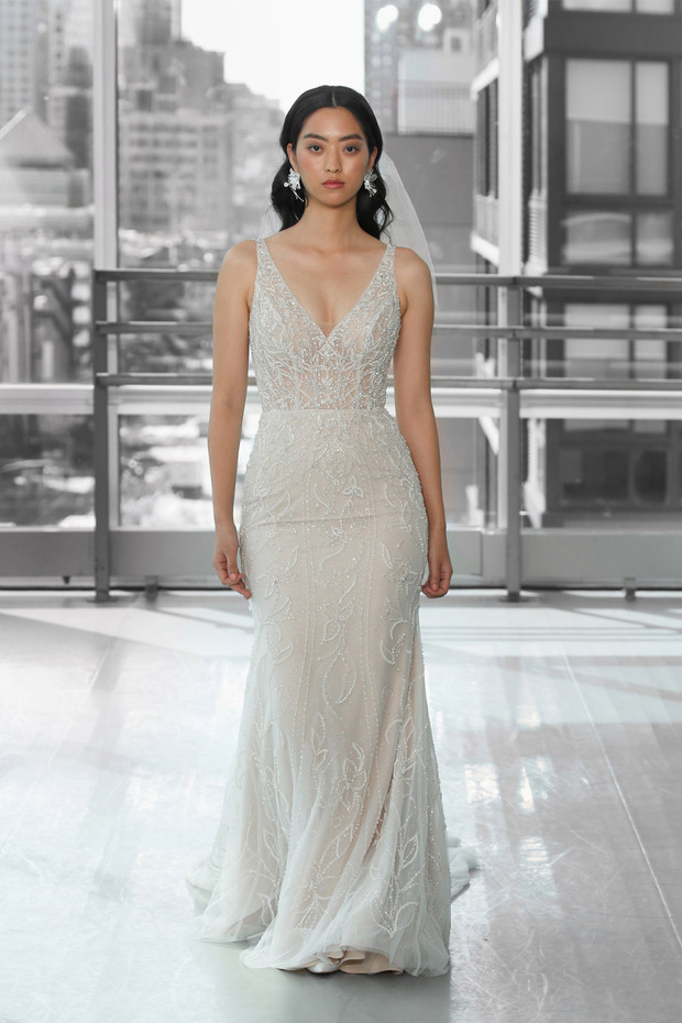 Elegant bride in beaded wedding dress with city view