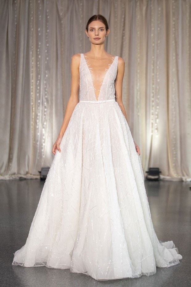 Elegant bride in a stunning white wedding gown on a runway