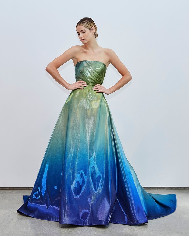 Woman in a stunning blue and green ombre strapless gown