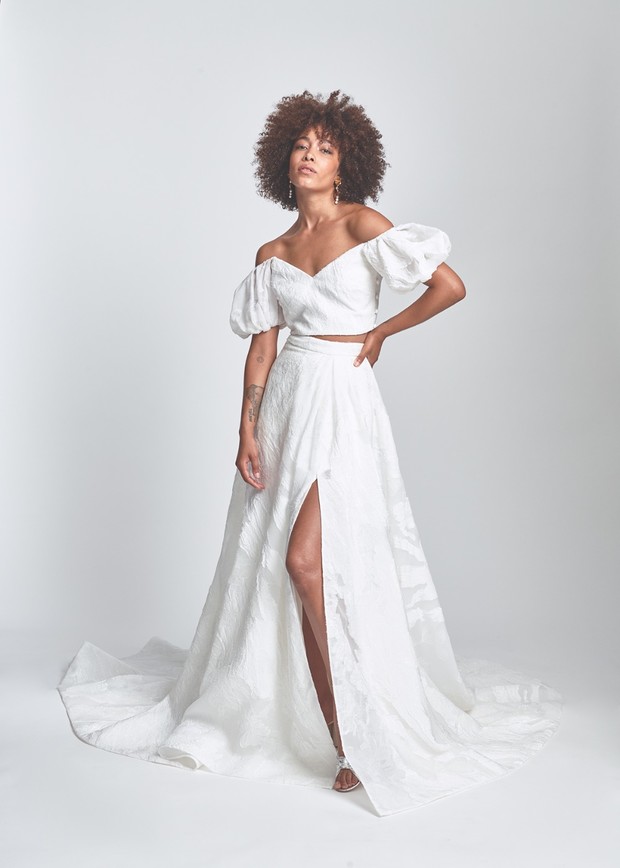 Woman in chic white two-piece off shoulder wedding dress