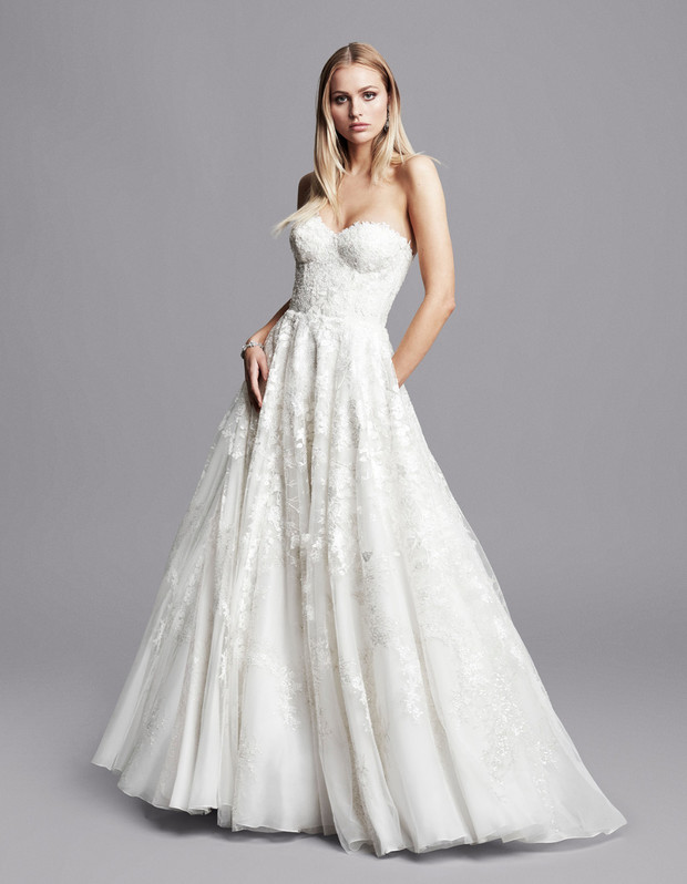 Elegant strapless wedding dress with delicate lace details and flowing skirt