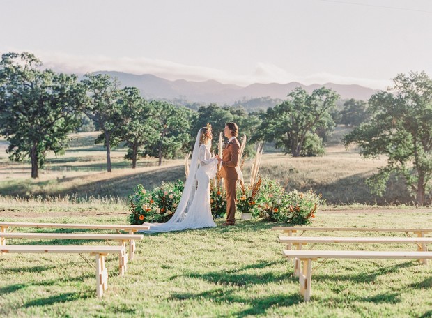 Outdoor wedding ceremony with mountains in background