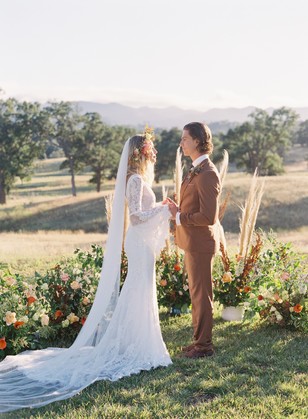 Bride and groom exchanging vows in scenic outdoor ceremony