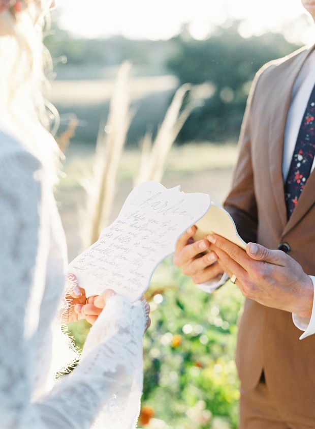 Bride and groom exchanging vows at outdoor wedding