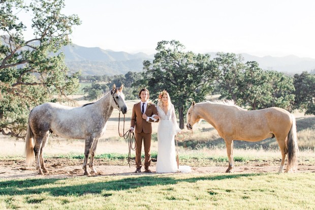 Rustic wedding photo with bride groom and two horses