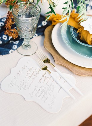 Elegant wedding place setting with menu and gold forks
