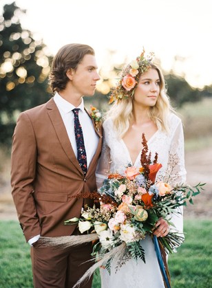 Boho chic wedding couple with floral crown and bouquet