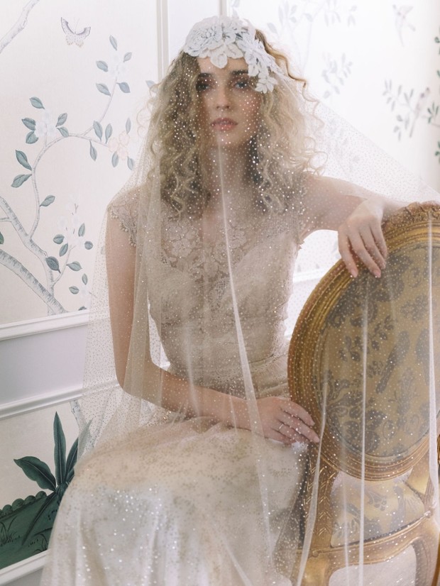 Bride in vintage lace wedding gown and sparkly veil