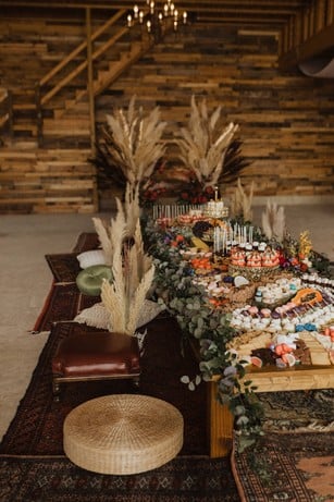 a rustic pillow seating dessert grazing table