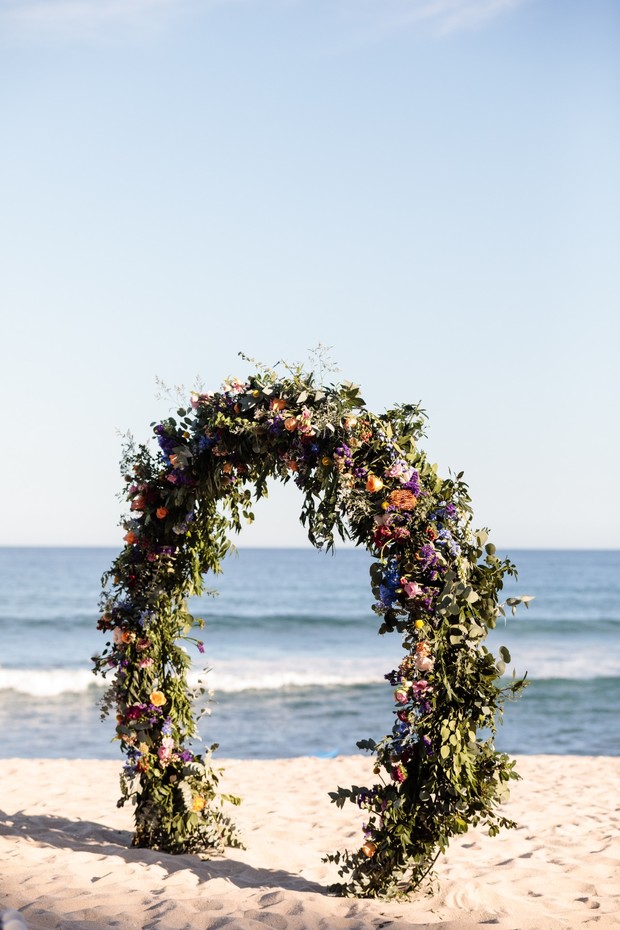 floral wedding arbor on the beach