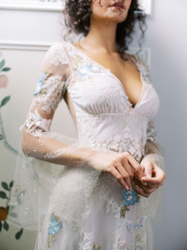 Woman in floral lace gown with sheer sleeves detail
