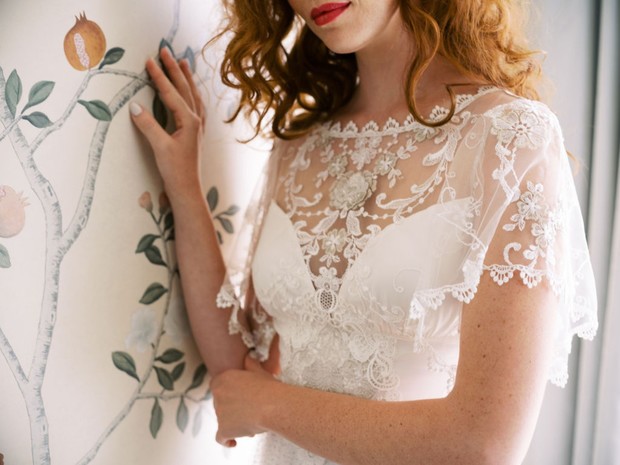 Elegant bride in a delicate lace wedding dress and red lips