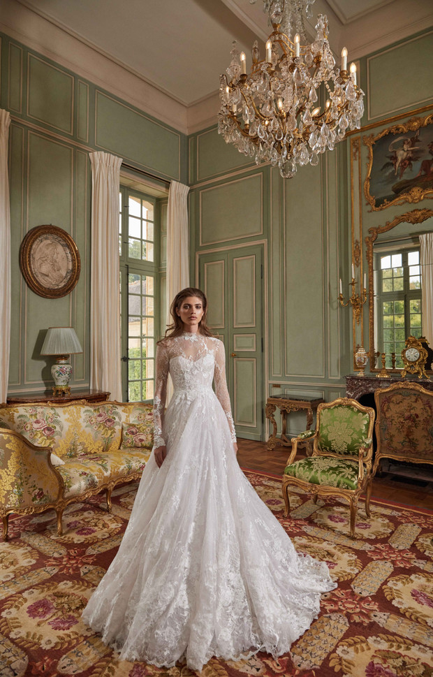 Elegant bride in a lace wedding dress in luxurious room