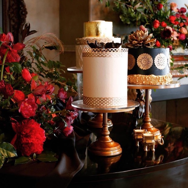 Elegant wedding cakes with gold accents, surrounded by flowers