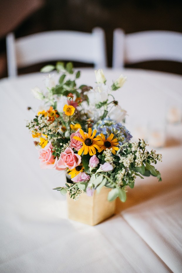Vibrant floral centerpiece on a table setting at a wedding reception