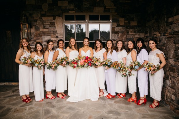 bridesmaids in white jumpsuits