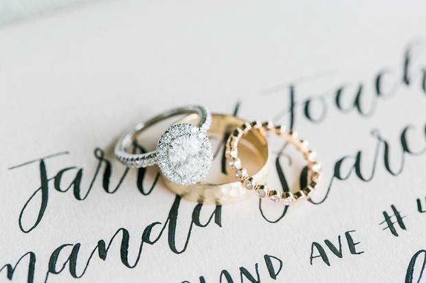 Elegant diamond engagement ring with wedding bands on a card