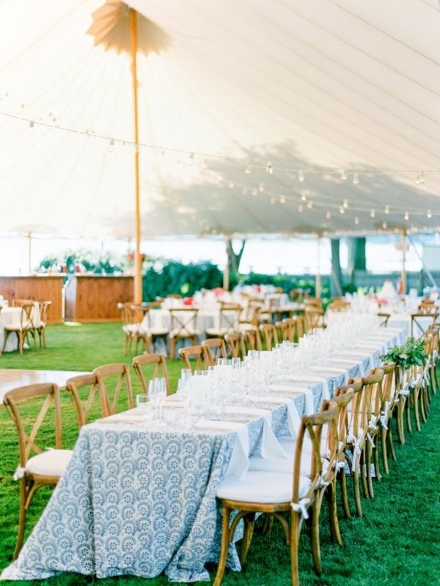 Elegant outdoor wedding reception table setting under a tent