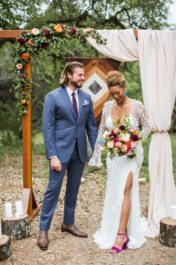 Happy couple at outdoor wedding ceremony, smiling at each other