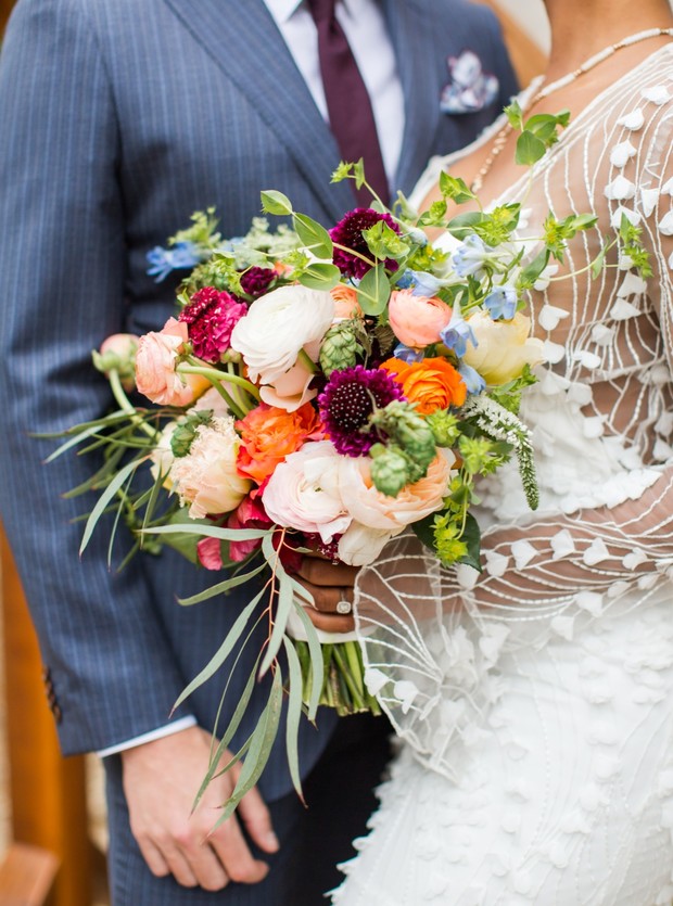 Bride and groom with a vibrant wedding bouquet and floral colors