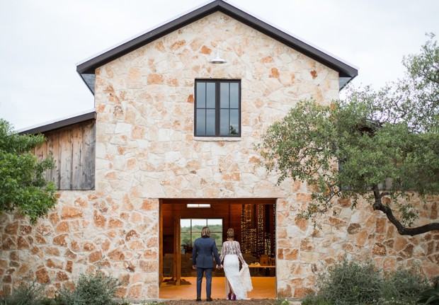 Couple enters a stone building on their wedding day ceremony