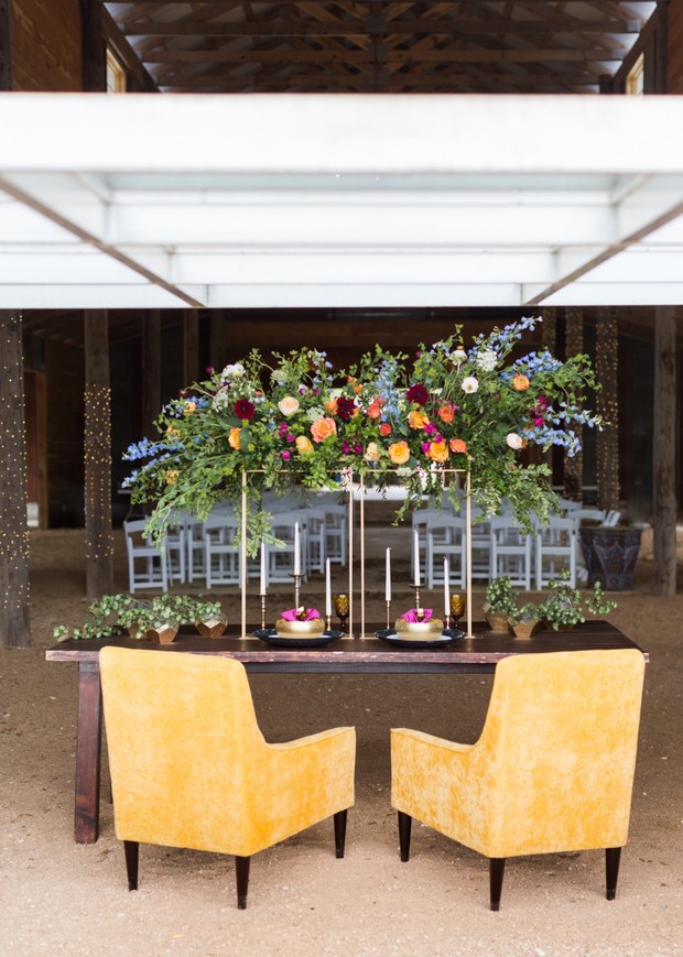 Romantic wedding table with yellow chairs and floral decor