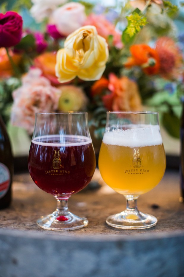 Two craft beers in glasses, with a colorful floral background