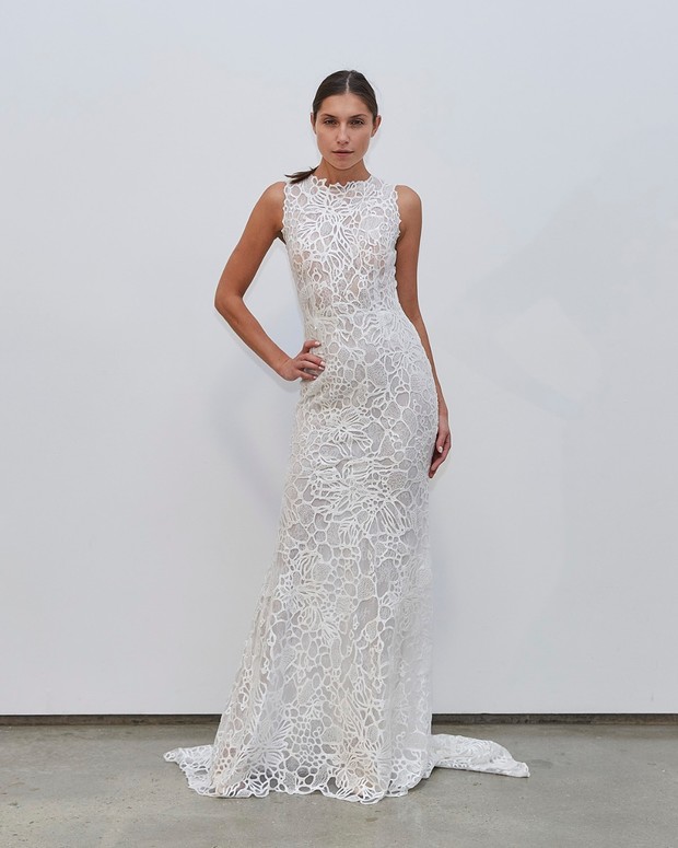 Elegant bride in a stunning white lace wedding dress with a train