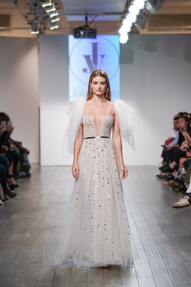 Fashion model walks runway in stunning sequin wedding dress