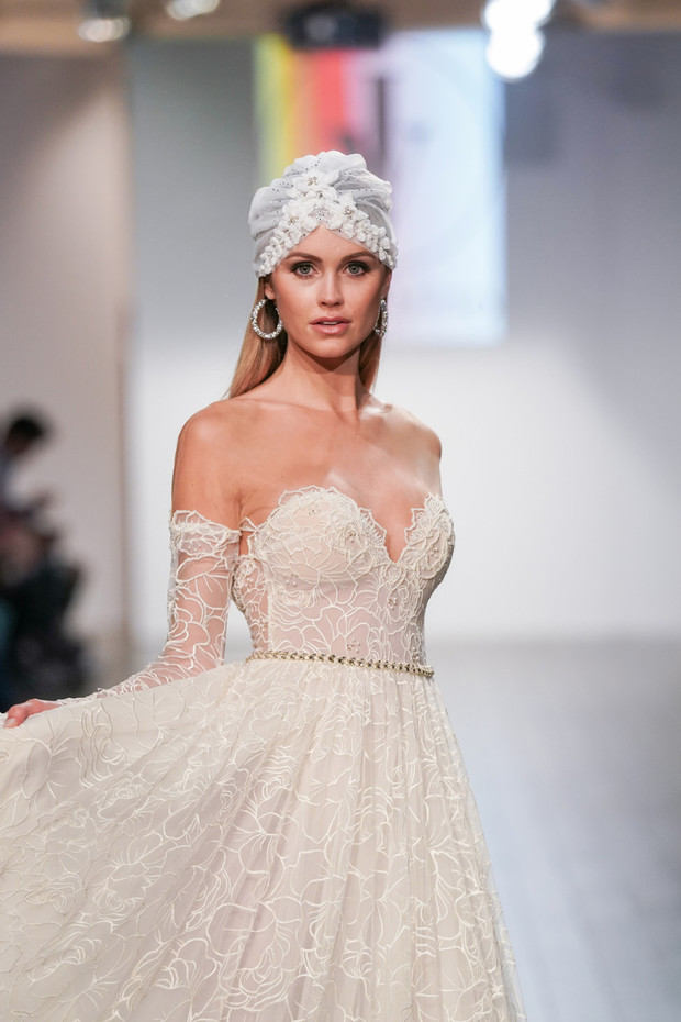 Beautiful bride in elegant wedding gown on fashion runway